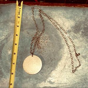 Long gold-toned necklace with large pendant in matte gold